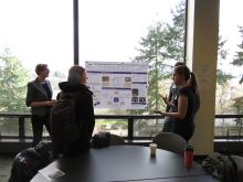 Discussion at a poster presentation (2018 Praxis)