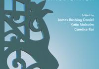 A blue book cover with a large green metal sculpture of a face.