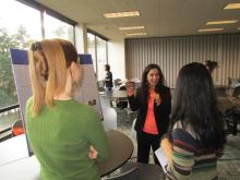 a presenter shares information with two audience members