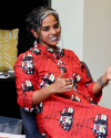 Dr. Anu in a red dress in conversation
