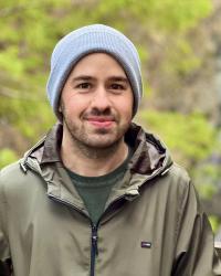 Photo of Furkan Kir, outdoors with greenery in the background