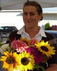 Photo of Natalie with sunflowers