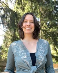 Brown-haired white woman smiles at the camera