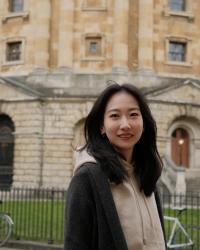 Asian woman in front of English library