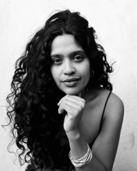 Black and white image of woman with long curly hair