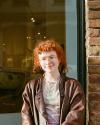 Lillian Pettigrew is white with red hair and glasses.  