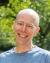 Charles LaPorte smiling under cherry trees on UW campus