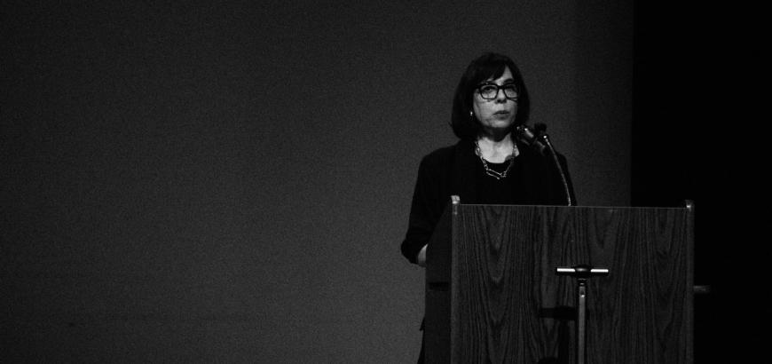 Professor Pimone Triplett reading at a podium