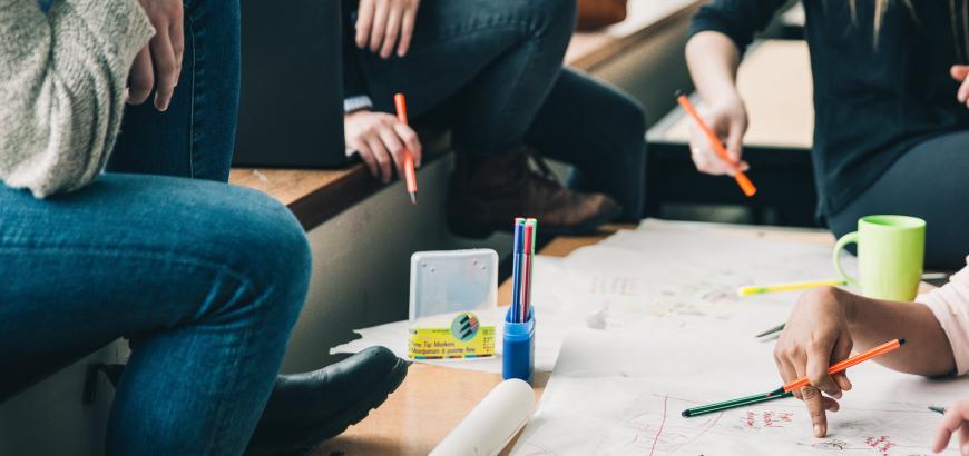Decorative image of students working together on a document