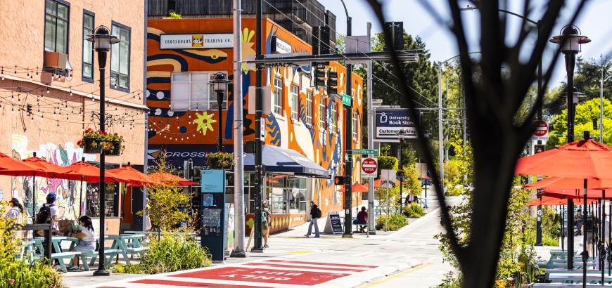 Image of University Avenue from University District Station with colorful buildings in the background